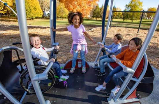 Children on Inclusive Playground Equipment
