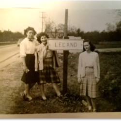 Women around old Leland sign