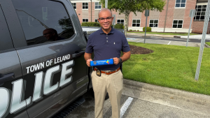 Police chief holding seatbelt cover