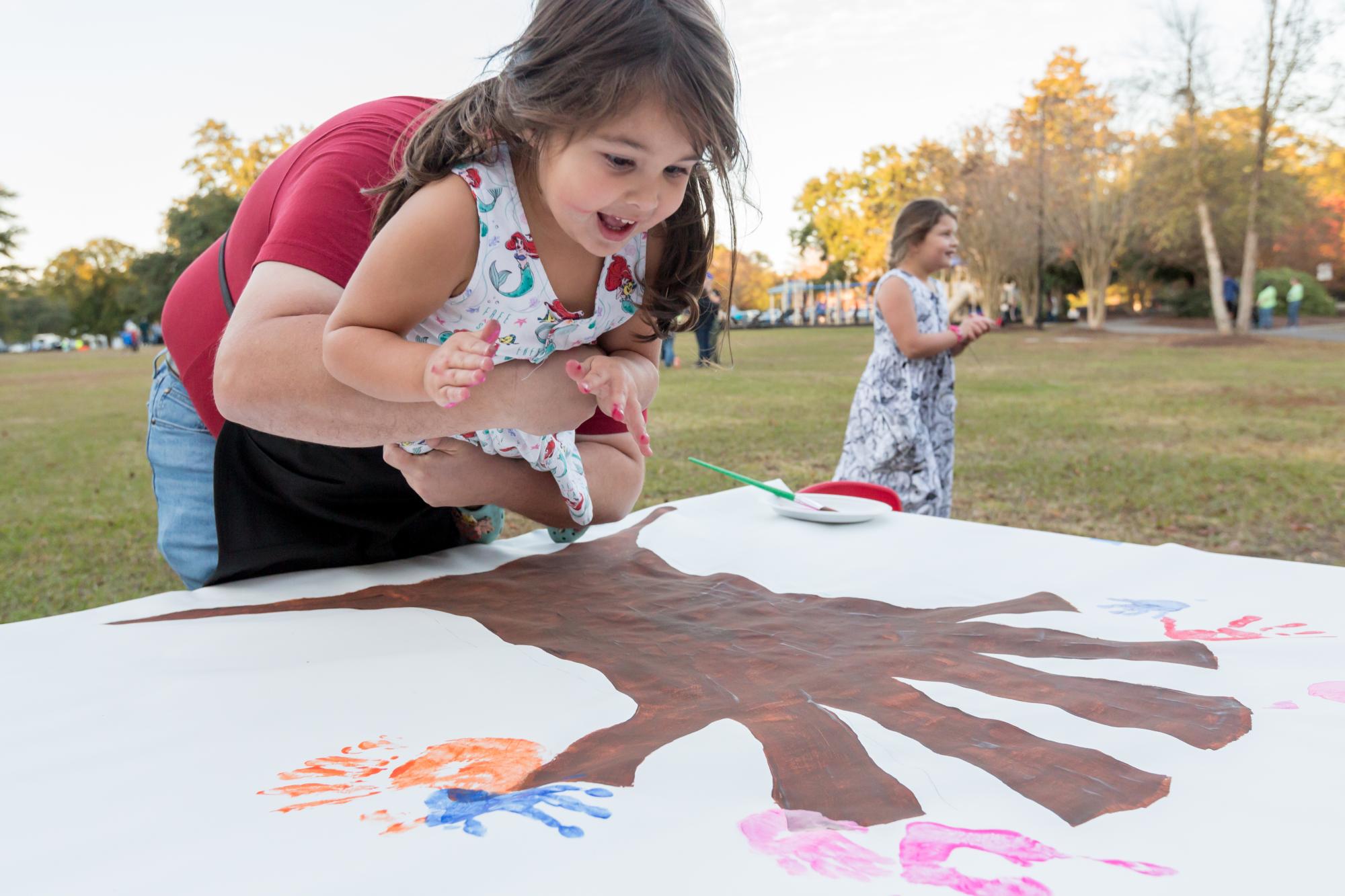 Child participating in a community art project