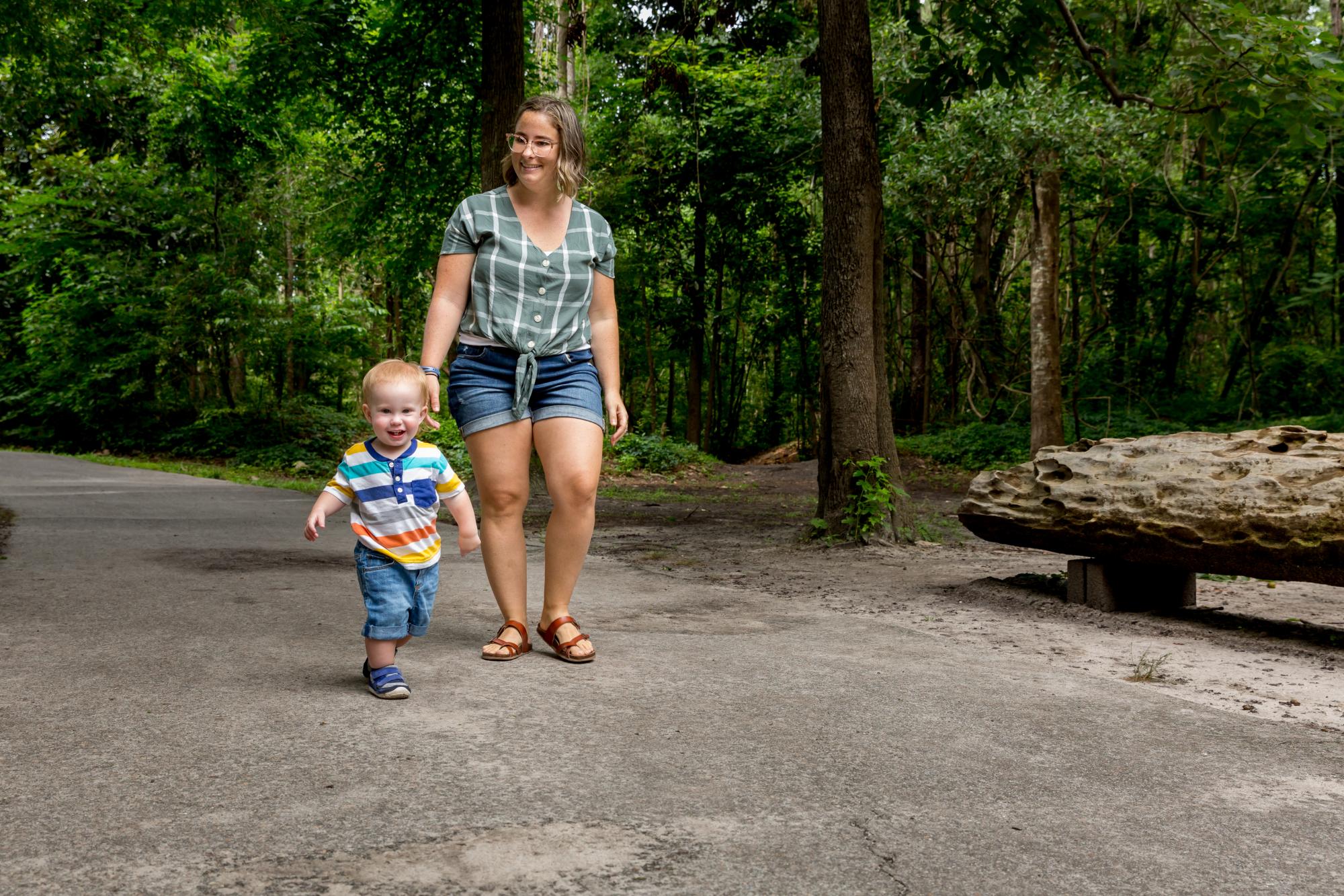 Mom walking with baby in park