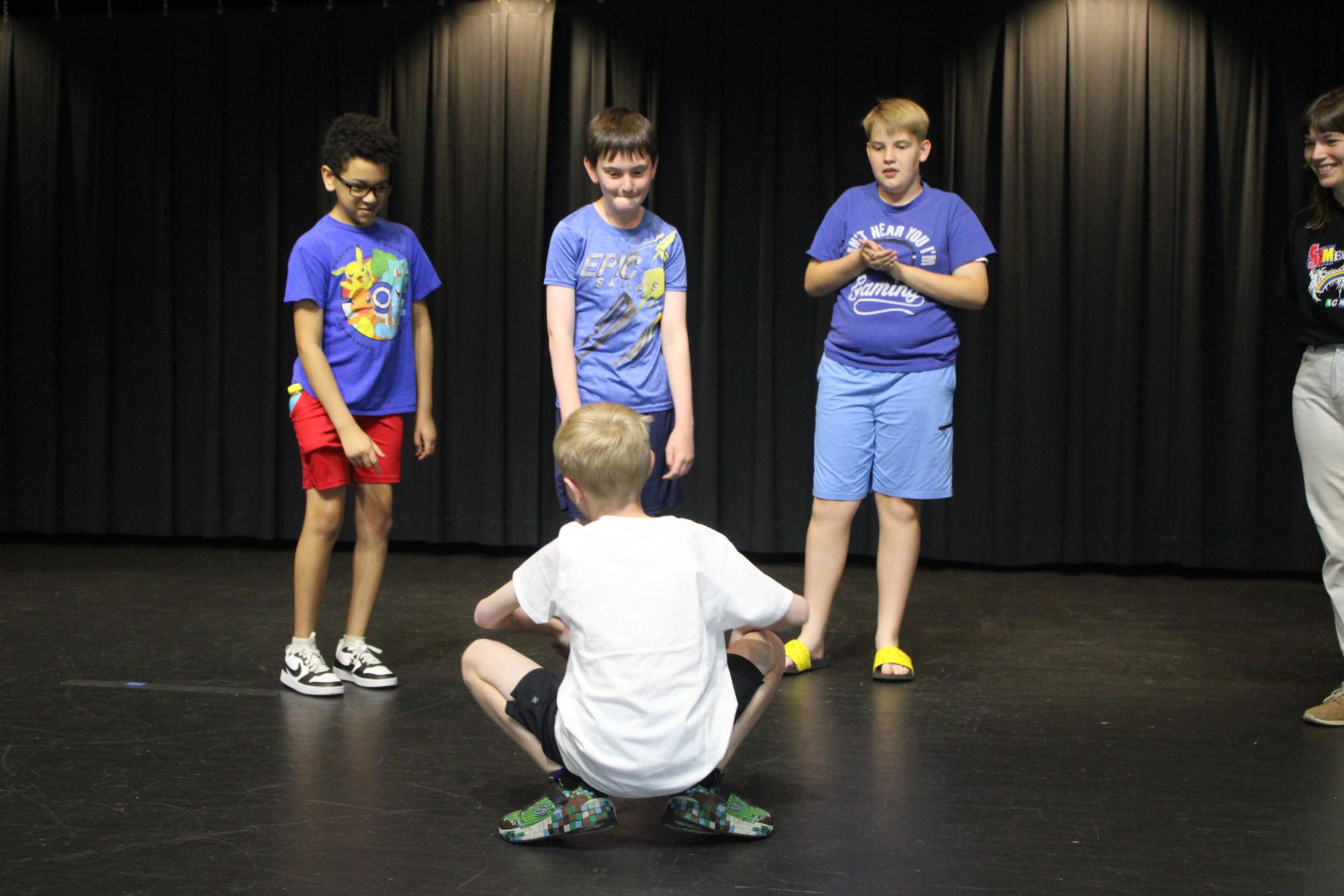 Group of kids on stage acting