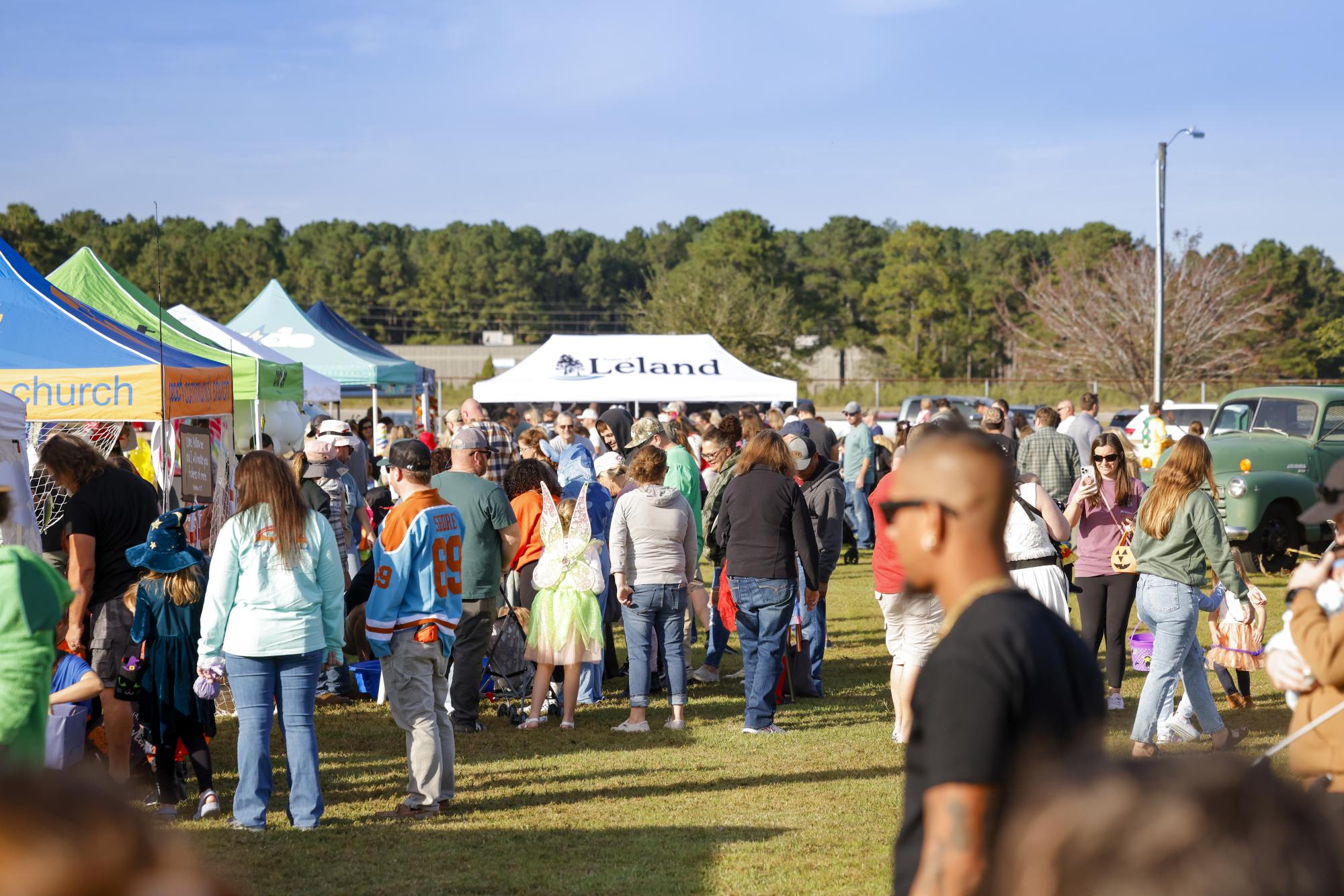 Crowd of people with Town of Leland Tent
