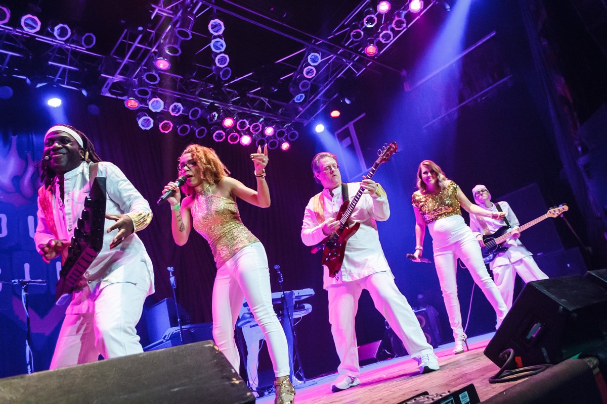 5 members of band performing on stage