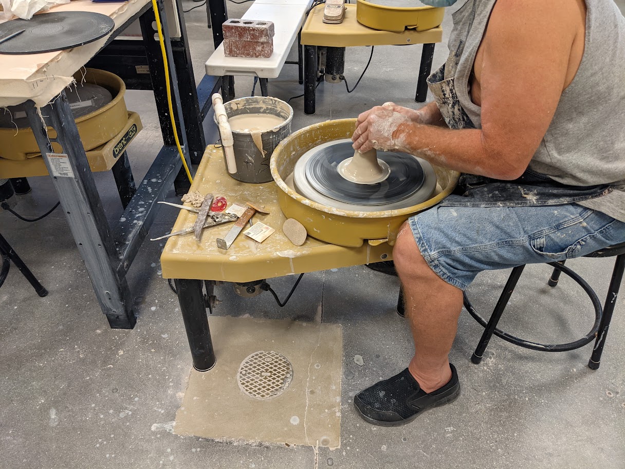 Person using the pottery wheel